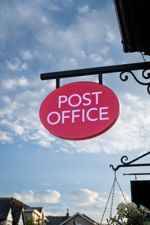 An old fashioned Post Office sign hanging outside a main street Post Office or traditional sub post...