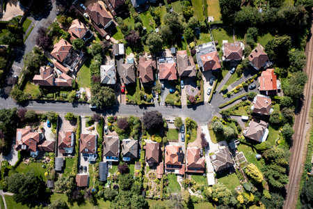 Aerial map style landscape view of detached suburban homes with drieveways and gardens on an exclusive residential development in a small village environmentの写真素材