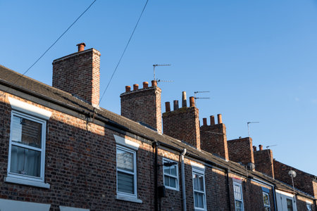 A row of cheap terraced houses to rent and buy for first time buyers representing housing costs with copy space aboveの写真素材