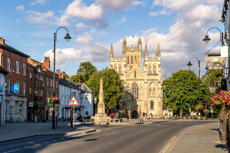 SELBY, NORTH YORKSHIRE, UK - AUGUST 8, 2023.  Townscape skyline view of the ancient architecture of Selby Abbey in the popular North Yorkshire market town with war memorial and copy spaceのeditorial素材