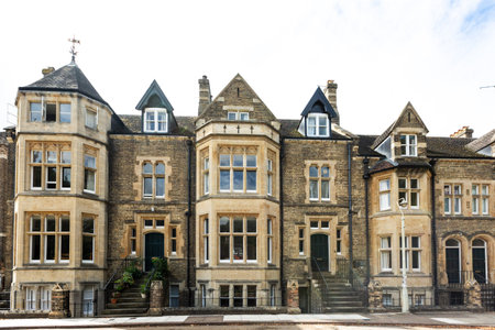 Landscape view of a row of traditional Victorian townhouses with four storeys from basement to loft with copy space aboveの写真素材
