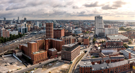 An aerial panoramic view of Leeds cityscape skyline with Granary Wharf and Bridgewater Place skyscraper at sunriseの写真素材