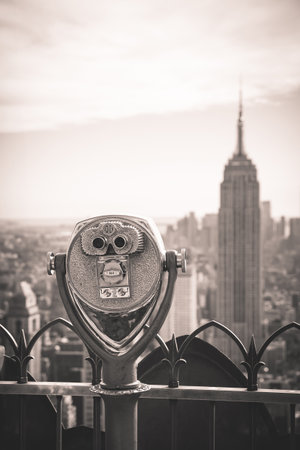 Old fashioned coin operated binoculars overlooking the Empire State building and surrounding...
