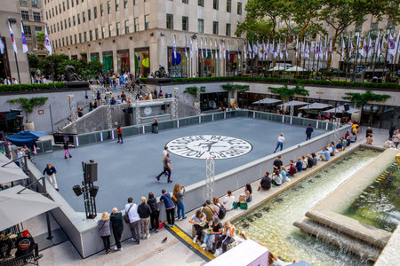ROCKERFELLER CENTER, NEW YORK, USA, - SEPTEMBER 15, 2023.  The roller skater rink in the Lower Plaza of The Rockerfeller Center in New York City with people skatingのeditorial素材