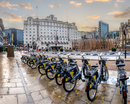 CITY SQUARE, LEEDS, UK - NOVEMBER 14, 2023. A row of bicycles for hire in the newly pedestrianised and low emissions zone at City Square in Leeds, West Yorkshire at sunsetのeditorial素材
