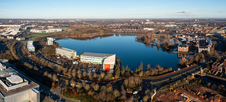 LAKESIDE, DONCASTER, UK - DECEMBER 6, 2023. An aerial view of the lake at Lakeside Village in Doncaster with shopping outlet and Doncaster Rovers FC Eco-Power football stadiumのeditorial素材