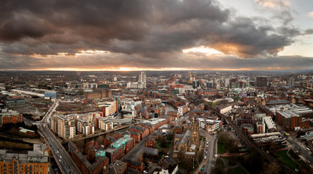 An aerial panoramic view of Leeds cityscape skyline with Leeds Dock and the River Aire running through the city with dramatic sky at sunriseの写真素材