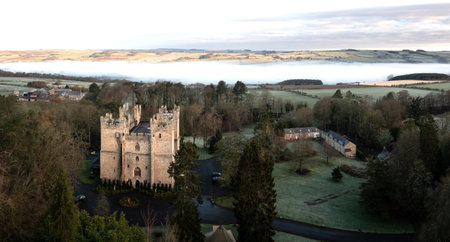LANGLEY CASTLE, NORTHUMBERLAND, UK - MARCH 16, 2024. An aerial view of the historic and medieval architecture of Langley Castle near Haydon Bridge in Northumberland with an early morning cloud inversion in the Tyne Valleyのeditorial素材