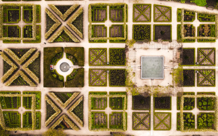 Aerial view directly above rows of landscaped flower beds in an English formal garden with water featuresの写真素材