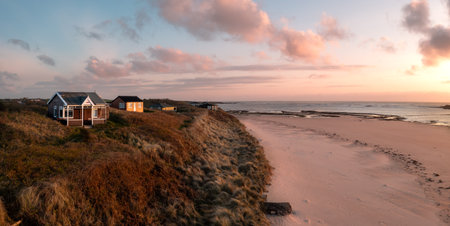 Aerial view of remote beach huts with a sea view on the Northumbrian sand dunes over looking Embleton Bay beach at sunsetの写真素材
