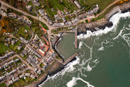 Aerial landscape panorama directly above the Northumberland fishing village of Craster which is famous for it's smoked kippersの写真素材