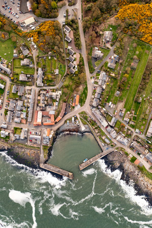 Aerial landscape panorama directly above the Northumberland fishing village of Craster which is famous for it's smoked kippersの写真素材