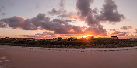 Remote beach huts with a sea view on the Northumbrian sand dunes over looking Embleton Bay beach at sunsetの写真素材