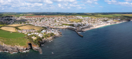 Aerial landscape of the quaint Cornish fishing town of Porthleven in Cornwall with rocky coastline...