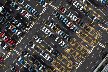 Aerial view directly above a large parking lot with car parking spaces for disabled drivers or people with disabilitiesの写真素材