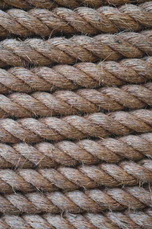 A full frame background of thick shipping rope tightly wrapped together and made from durable natural fibres such as Jute in a vertical orientation with copy spaceの写真素材