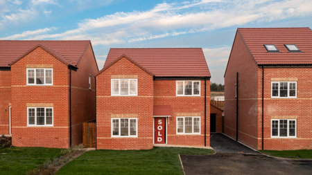 A row of new build detached homes on a construction site for the UK Government's Right To Buy scheme with sold signの写真素材