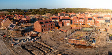 Aerial panoramic landscape view of a new build housing estate with houses under construction to fill the gap in the UK home shortage and supplement the UK Government's Right To Buy policyの写真素材