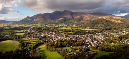 Aerial panoramic landscape of the Lake District town of Keswick on a beautiful Summer day with Bassenthwaite Lake and Skiddaw in The Northern Fells behindの写真素材