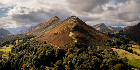 Aerial panorama landscape view of Catbells mountain overlooking Derwent Water in The English Lake District National Park with Autumnal sunlightの写真素材