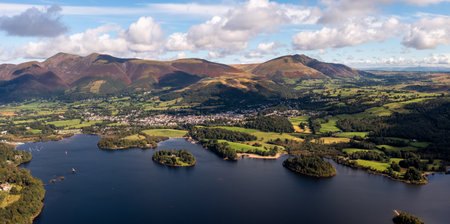 Aerial panoramic landscape of the Lake District town of Keswick on the shores of Derwent Water on a beautiful Summer day with Skiddaw and The Northern Fells in the distanceの写真素材