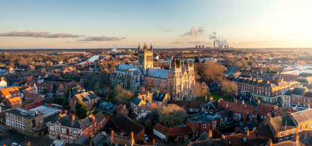 Aerial panoramic landscape of the North Yorkshire market town of Selby with the historic Selby Abbey cathedral and Drax Power Station in the distance with dramatic sunsetの写真素材