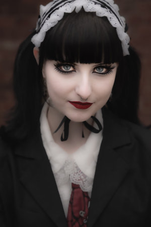 A close up of a girl cosplayer dressed as a scary doll with flawless complexion and beautiful eyesの写真素材