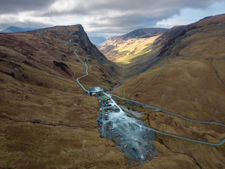 Aerial panorama landscape view of the Honister Slate Mine and Pass road in The English Lake District National Park in Cumbria, UK with surrounding mountainsの写真素材