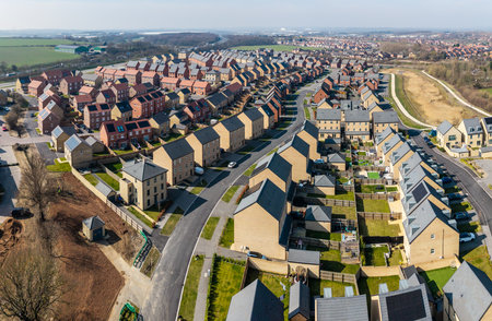 Aerial panorama landscape view of a large new build housing development on green belt land due to a housing shortage with characterless design for first time buyersの写真素材