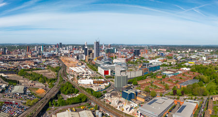 An aerial panoramic view of Birmingham cityscape skyline with the HS2 construction site and railway tracks running alongside University buildings on Curzon Streetの写真素材