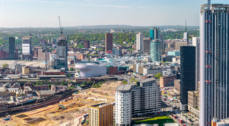 An aerial panoramic view of Birmingham cityscape skyline with the HS2 construction site and railway tracks running alongside University buildings on Curzon Streetの写真素材