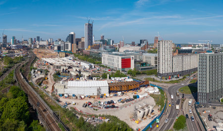 An aerial panoramic view of Birmingham cityscape skyline with the HS2 construction site and railway tracks running alongside University buildings on Curzon Streetの写真素材