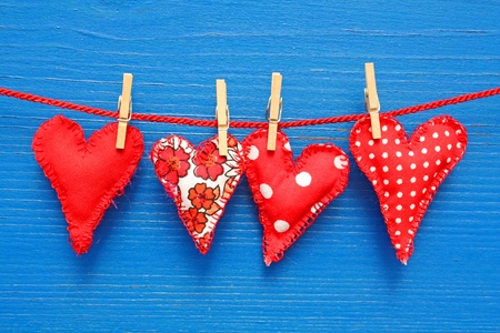 Four handmade hearts on a red string