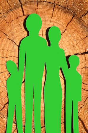 Abstract family cutout from paper, on wood backgroundの写真素材
