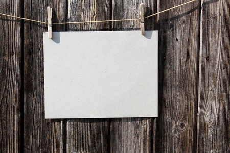 A blank piece of paper on a old wooden fenceの写真素材