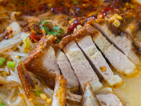 Spicy noodle, Tomyam noodle with crispy pork.の写真素材