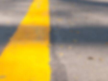 Natural bright blurred background of asphalt road and yellow line.の写真素材