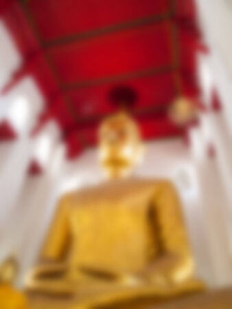 Natural bright blurred background of gold Buddha statue.の写真素材