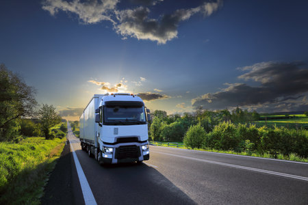 truck on the road at sunset in summer, transportation and logisticsの写真素材