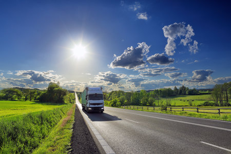 truck on the road in the countryside with blue sky and sunの写真素材