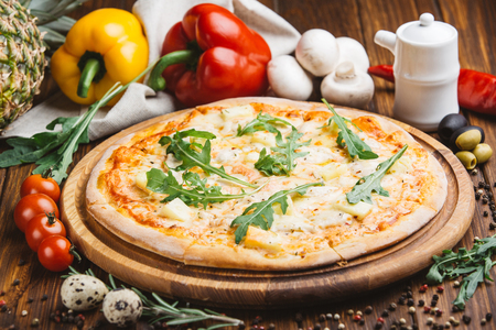 Hawaiian pizza on wooden plateの写真素材