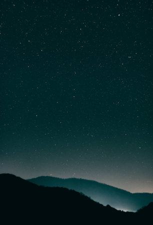 Night starscape with highlighted hillsの写真素材
