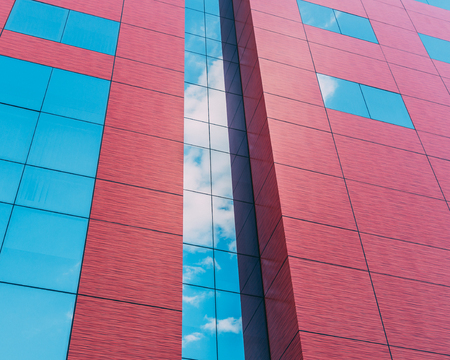 Red office building reflect the cloudsの写真素材
