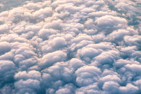 Cloudy view from plane in sunset lightの写真素材
