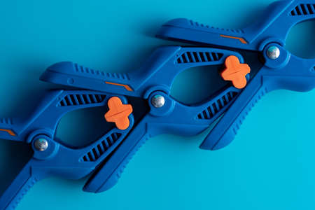 Isolated blue clamp tool on the blue backgroundの写真素材