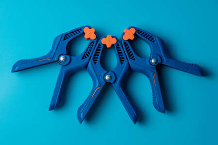 Isolated blue clamp tool on the blue backgroundの写真素材