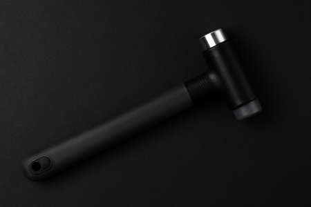 Steel claw hammer with rubber handle, isolated on black backgroundの写真素材