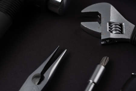 Black metal tools on black backgroundの写真素材