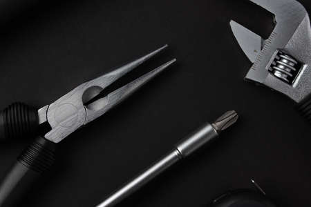 Black metal tools on black backgroundの写真素材