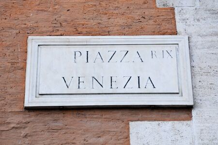Road sign indicating a street name in Italian "Piazza Venezia" in English means Venezia square, romeのeditorial素材